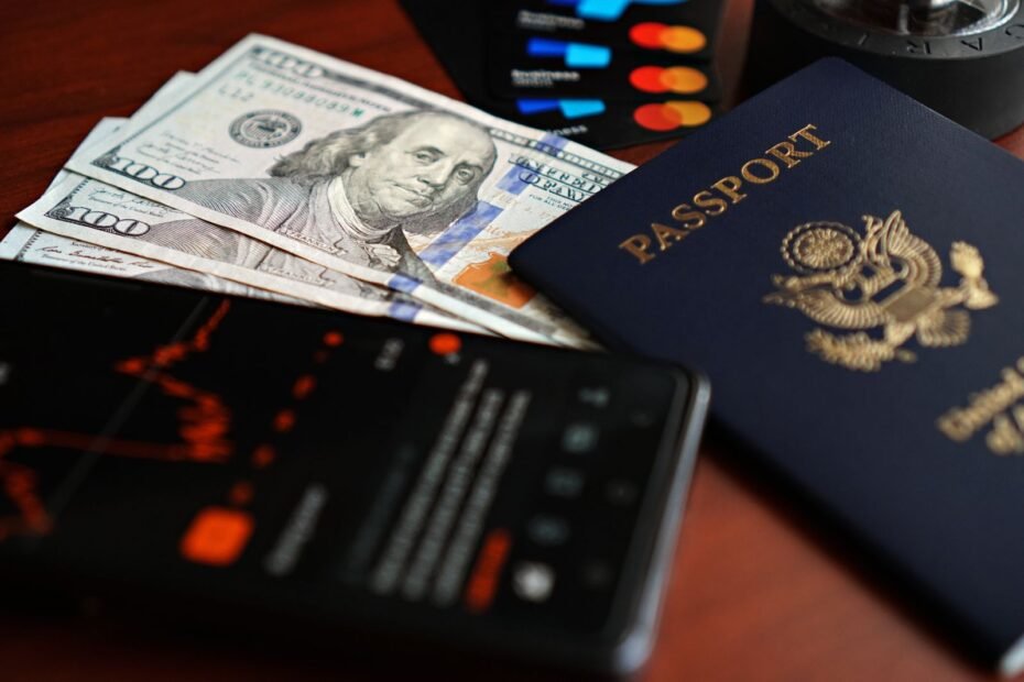 Passport, foreign currency and payment cards arranged for international travel planning.
