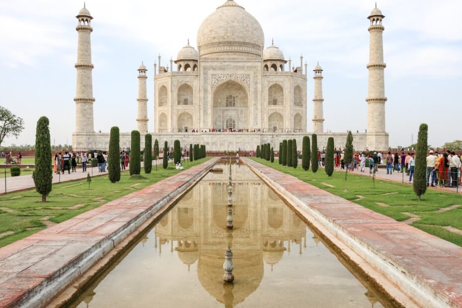 The Taj Mahal in Agra reflected in its central pool, representing travel planning for India.